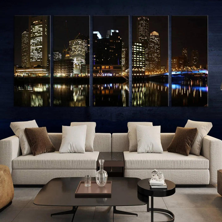 The Boston Night Skyline Cityscape View Wall Art Canvas Print depicts a triptych of the illuminated city reflected in water, enhancing a modern living room with its vibrant imagery. This gallery-wrapped masterpiece on museum-quality canvas brings an artistic flair to your space.