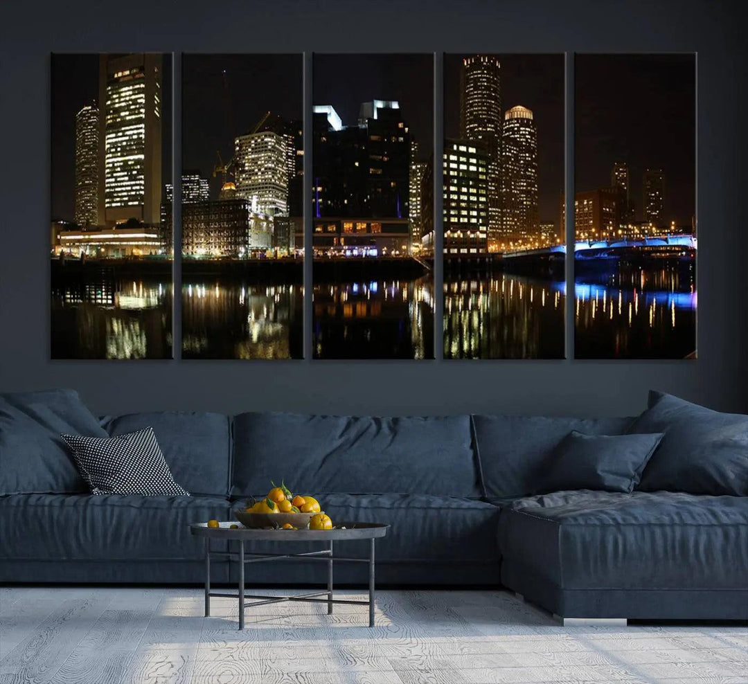 The Boston Night Skyline Cityscape View Wall Art Canvas Print depicts a triptych of the illuminated city reflected in water, enhancing a modern living room with its vibrant imagery. This gallery-wrapped masterpiece on museum-quality canvas brings an artistic flair to your space.