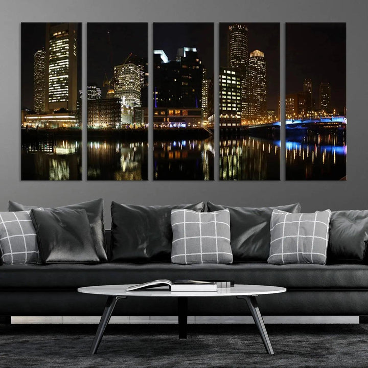 The Boston Night Skyline Cityscape View Wall Art Canvas Print depicts a triptych of the illuminated city reflected in water, enhancing a modern living room with its vibrant imagery. This gallery-wrapped masterpiece on museum-quality canvas brings an artistic flair to your space.