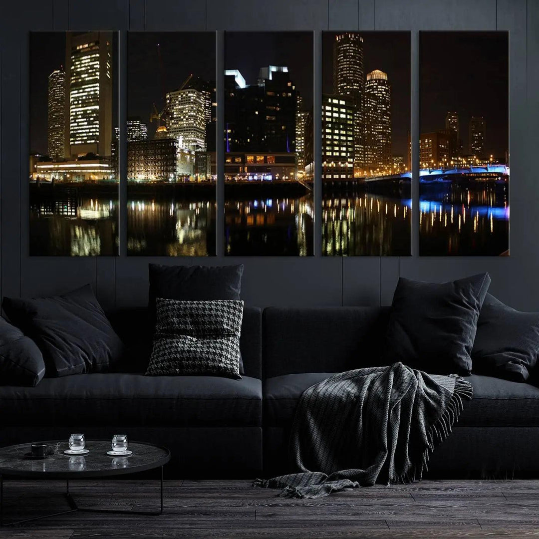 The Boston Night Skyline Cityscape View Wall Art Canvas Print depicts a triptych of the illuminated city reflected in water, enhancing a modern living room with its vibrant imagery. This gallery-wrapped masterpiece on museum-quality canvas brings an artistic flair to your space.