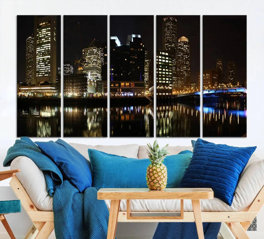 The Boston Night Skyline Cityscape View Wall Art Canvas Print depicts a triptych of the illuminated city reflected in water, enhancing a modern living room with its vibrant imagery. This gallery-wrapped masterpiece on museum-quality canvas brings an artistic flair to your space.