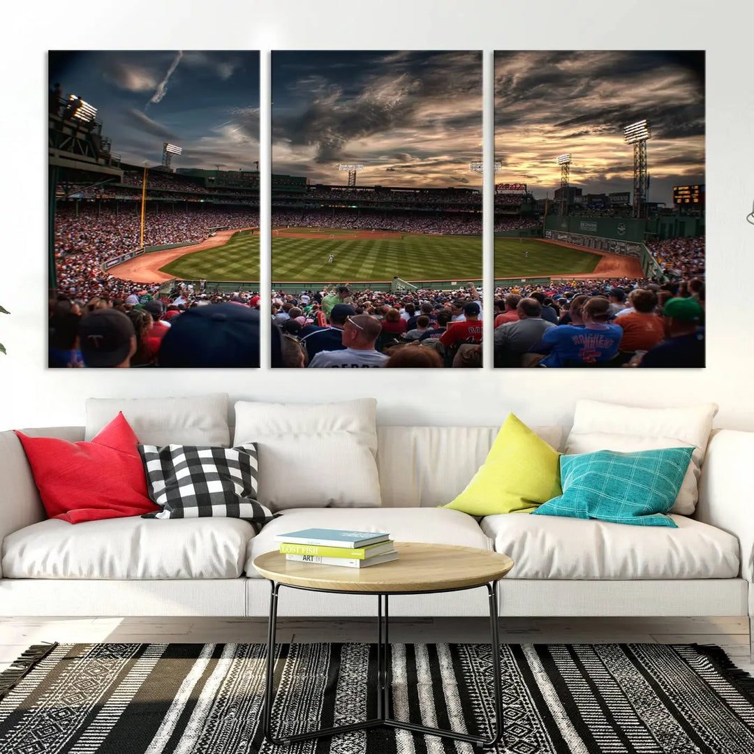 The Boston Red Sox Baseball Team Print, featuring Massachusetts's Fenway Park Stadium, brings charm and a gallery-quality finish to a cozy living room. It captures the essence of a crowded baseball stadium at sunset.