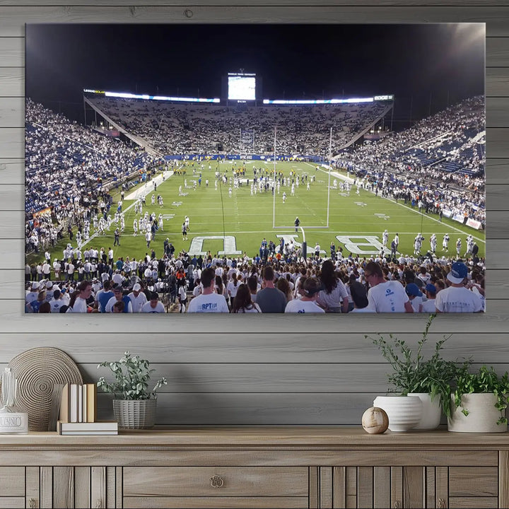 The living room is enhanced by a stunning triptych featuring the Brigham Young University Cougars Football Team Print. This premium canvas captures the vibrant atmosphere of Provo's LaVell Edwards Stadium at night, vividly portraying spectators and players on a well-lit field to bring an electrifying ambiance into your home.