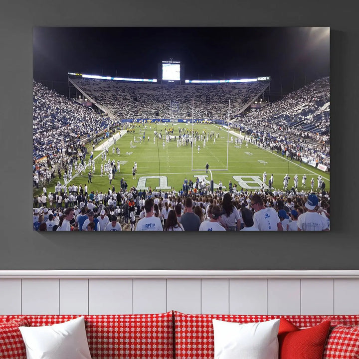 The living room is enhanced by a stunning triptych featuring the Brigham Young University Cougars Football Team Print. This premium canvas captures the vibrant atmosphere of Provo's LaVell Edwards Stadium at night, vividly portraying spectators and players on a well-lit field to bring an electrifying ambiance into your home.