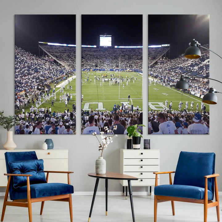 The living room is enhanced by a stunning triptych featuring the Brigham Young University Cougars Football Team Print. This premium canvas captures the vibrant atmosphere of Provo's LaVell Edwards Stadium at night, vividly portraying spectators and players on a well-lit field to bring an electrifying ambiance into your home.