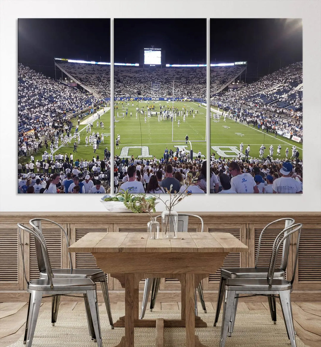 The living room is enhanced by a stunning triptych featuring the Brigham Young University Cougars Football Team Print. This premium canvas captures the vibrant atmosphere of Provo's LaVell Edwards Stadium at night, vividly portraying spectators and players on a well-lit field to bring an electrifying ambiance into your home.