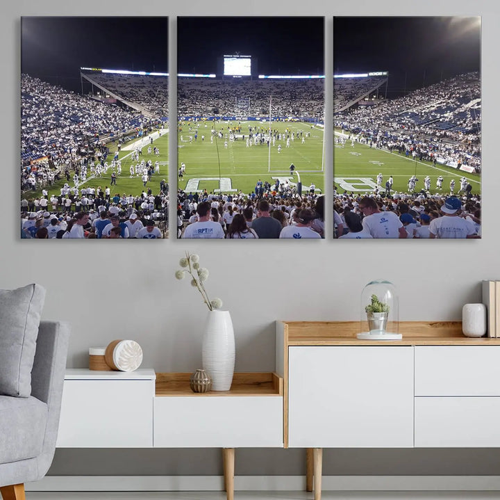 The living room is enhanced by a stunning triptych featuring the Brigham Young University Cougars Football Team Print. This premium canvas captures the vibrant atmosphere of Provo's LaVell Edwards Stadium at night, vividly portraying spectators and players on a well-lit field to bring an electrifying ambiance into your home.