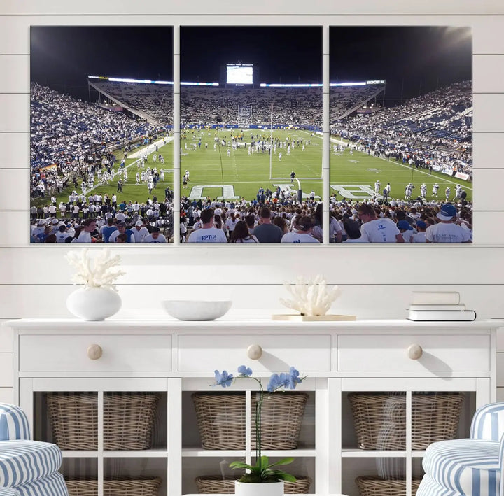 The living room is enhanced by a stunning triptych featuring the Brigham Young University Cougars Football Team Print. This premium canvas captures the vibrant atmosphere of Provo's LaVell Edwards Stadium at night, vividly portraying spectators and players on a well-lit field to bring an electrifying ambiance into your home.