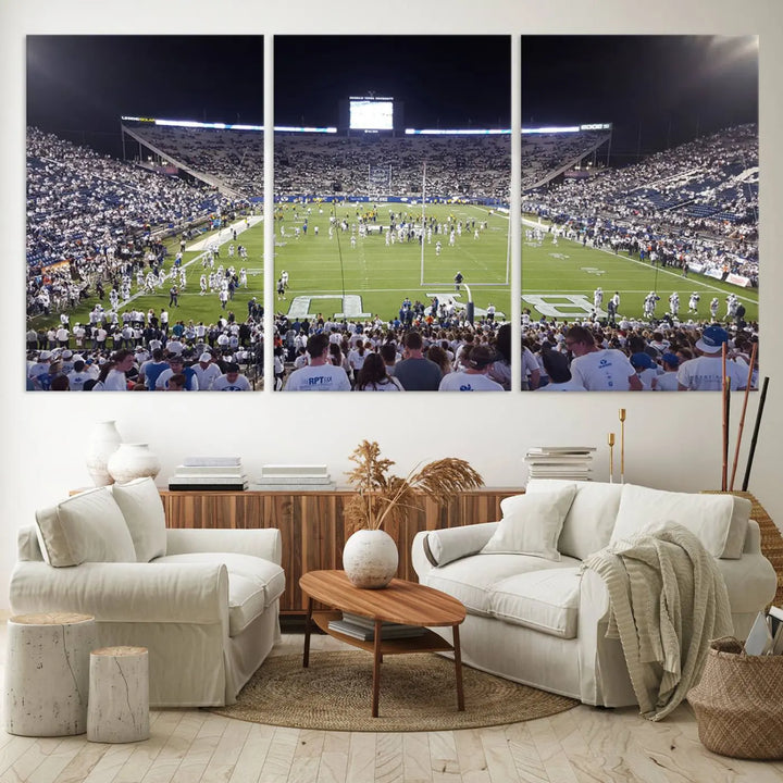 The living room is enhanced by a stunning triptych featuring the Brigham Young University Cougars Football Team Print. This premium canvas captures the vibrant atmosphere of Provo's LaVell Edwards Stadium at night, vividly portraying spectators and players on a well-lit field to bring an electrifying ambiance into your home.