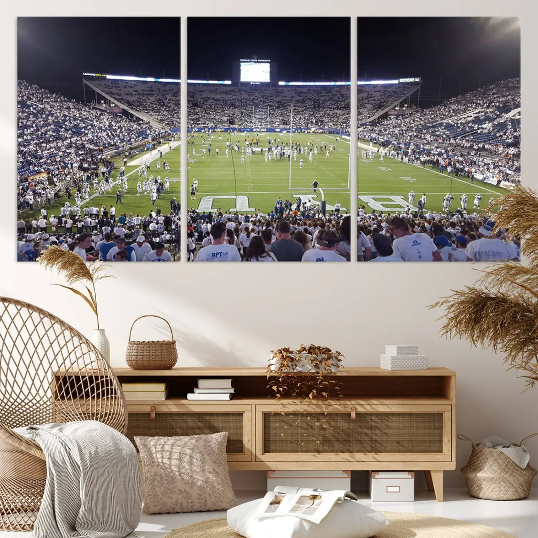 The living room is enhanced by a stunning triptych featuring the Brigham Young University Cougars Football Team Print. This premium canvas captures the vibrant atmosphere of Provo's LaVell Edwards Stadium at night, vividly portraying spectators and players on a well-lit field to bring an electrifying ambiance into your home.