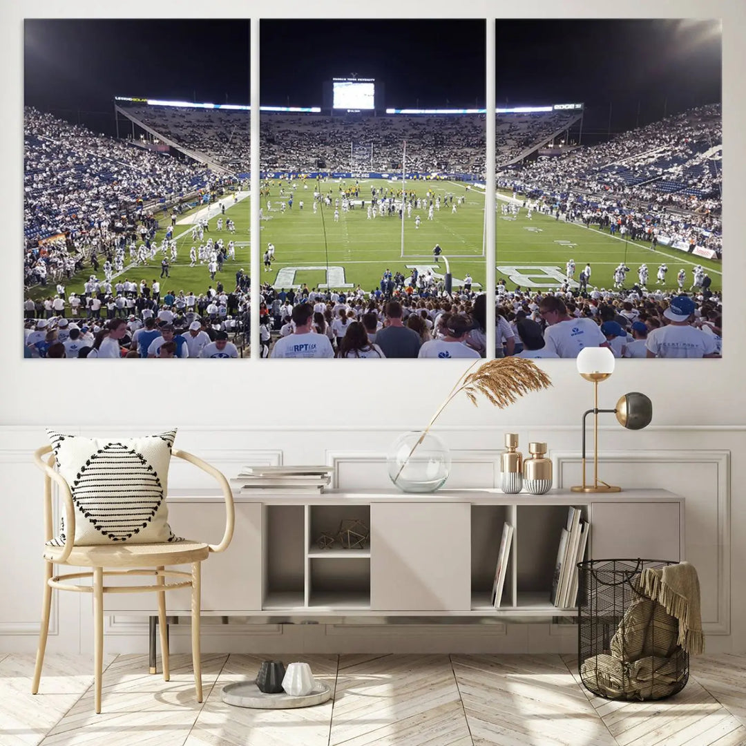 The living room is enhanced by a stunning triptych featuring the Brigham Young University Cougars Football Team Print. This premium canvas captures the vibrant atmosphere of Provo's LaVell Edwards Stadium at night, vividly portraying spectators and players on a well-lit field to bring an electrifying ambiance into your home.