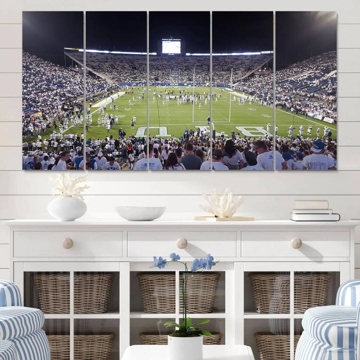 The living room is enhanced by a stunning triptych featuring the Brigham Young University Cougars Football Team Print. This premium canvas captures the vibrant atmosphere of Provo's LaVell Edwards Stadium at night, vividly portraying spectators and players on a well-lit field to bring an electrifying ambiance into your home.