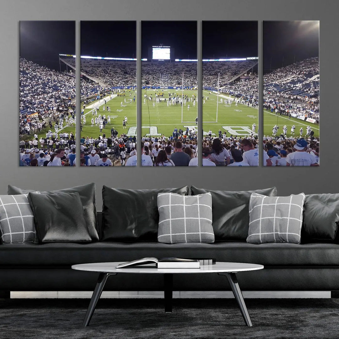 The living room is enhanced by a stunning triptych featuring the Brigham Young University Cougars Football Team Print. This premium canvas captures the vibrant atmosphere of Provo's LaVell Edwards Stadium at night, vividly portraying spectators and players on a well-lit field to bring an electrifying ambiance into your home.