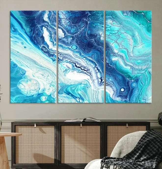 A Bright Blue Marble Fluid Effect Wall Art Abstract Canvas Wall Art Print graces the wall, presented on museum-quality canvas. This artwork comes ready to hang and is protected with a UV-coating for long-lasting vibrancy.