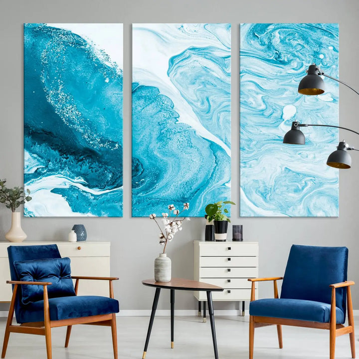 A modern living room showcasing the Bright Blue Marble Fluid Effect Wall Art Abstract Canvas, complete with a gallery-wrapped finish.