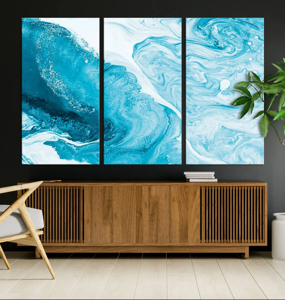 A modern living room showcasing the Bright Blue Marble Fluid Effect Wall Art Abstract Canvas, complete with a gallery-wrapped finish.