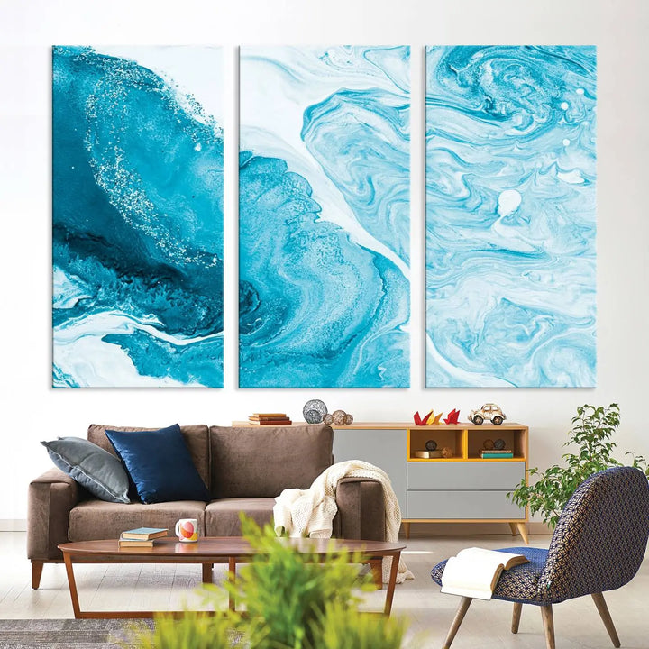 A modern living room showcasing the Bright Blue Marble Fluid Effect Wall Art Abstract Canvas, complete with a gallery-wrapped finish.