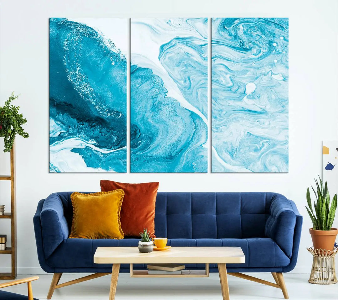 A modern living room showcasing the Bright Blue Marble Fluid Effect Wall Art Abstract Canvas, complete with a gallery-wrapped finish.