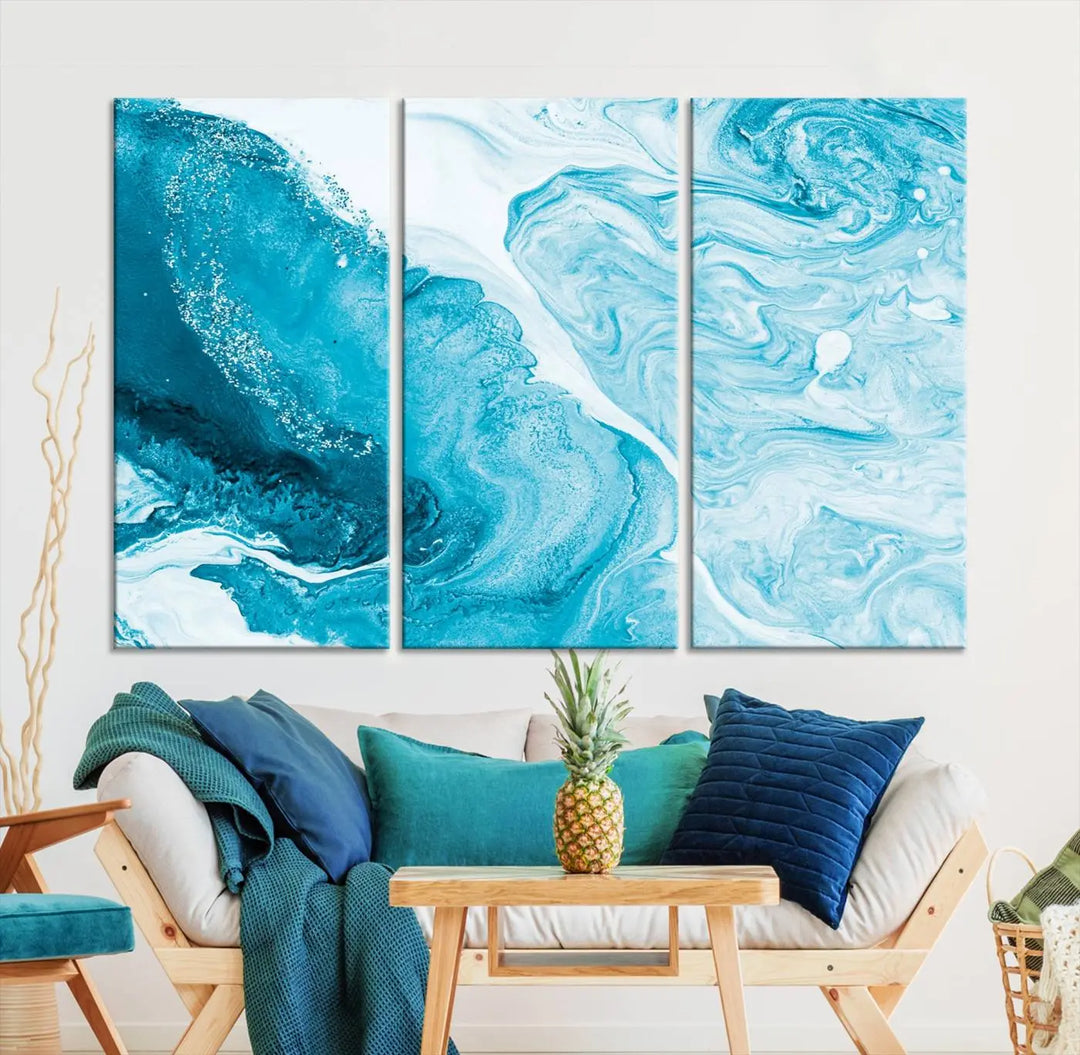 A modern living room showcasing the Bright Blue Marble Fluid Effect Wall Art Abstract Canvas, complete with a gallery-wrapped finish.