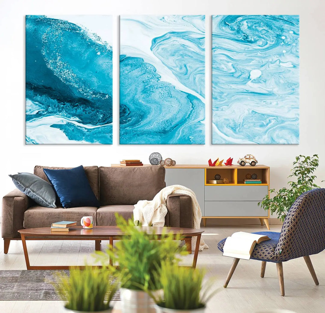 A modern living room showcasing the Bright Blue Marble Fluid Effect Wall Art Abstract Canvas, complete with a gallery-wrapped finish.