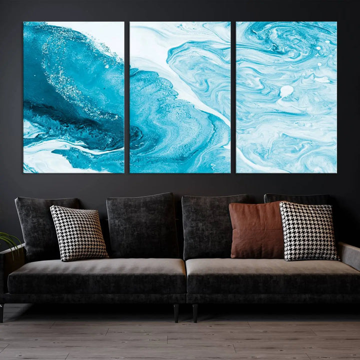 A modern living room showcasing the Bright Blue Marble Fluid Effect Wall Art Abstract Canvas, complete with a gallery-wrapped finish.