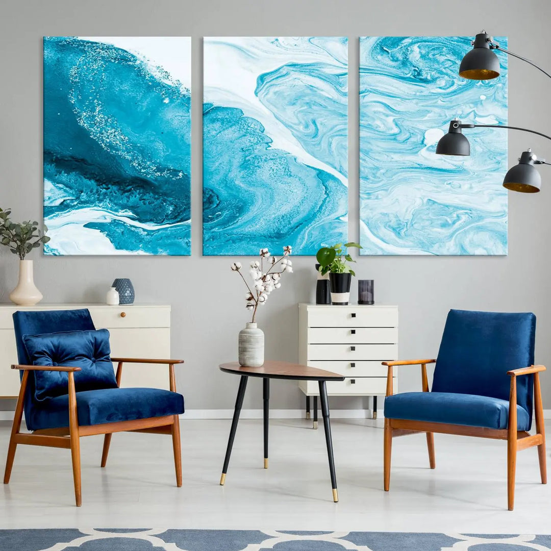 A modern living room showcasing the Bright Blue Marble Fluid Effect Wall Art Abstract Canvas, complete with a gallery-wrapped finish.