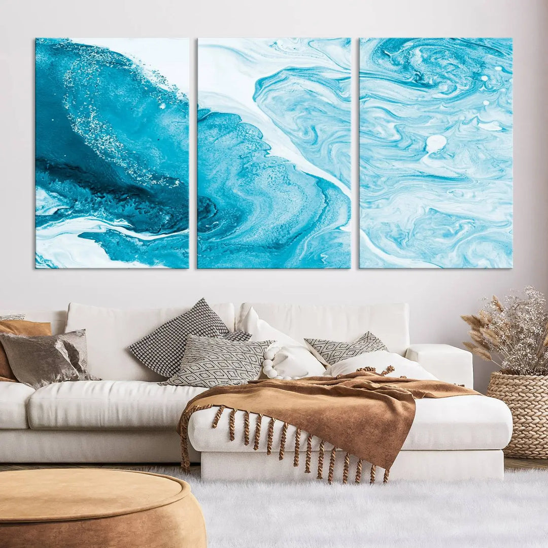 A modern living room showcasing the Bright Blue Marble Fluid Effect Wall Art Abstract Canvas, complete with a gallery-wrapped finish.