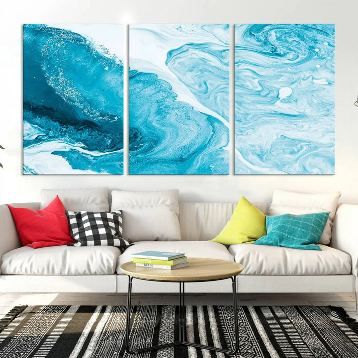 A modern living room showcasing the Bright Blue Marble Fluid Effect Wall Art Abstract Canvas, complete with a gallery-wrapped finish.