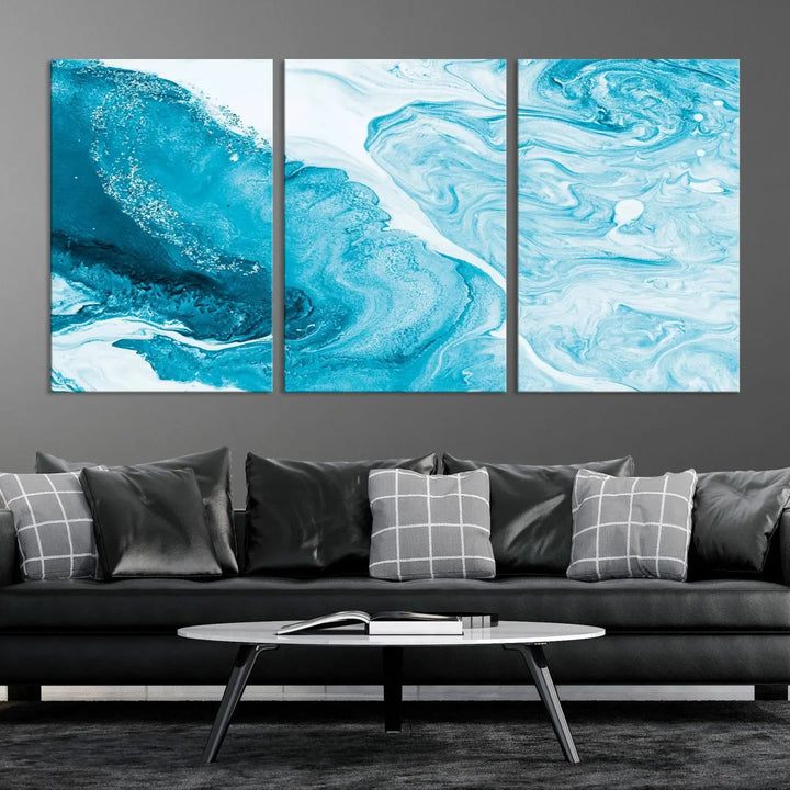 A modern living room showcasing the Bright Blue Marble Fluid Effect Wall Art Abstract Canvas, complete with a gallery-wrapped finish.