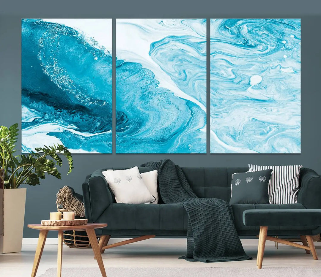 A modern living room showcasing the Bright Blue Marble Fluid Effect Wall Art Abstract Canvas, complete with a gallery-wrapped finish.