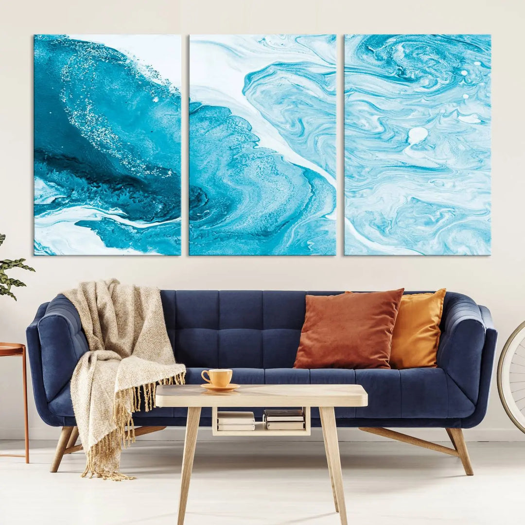 A modern living room showcasing the Bright Blue Marble Fluid Effect Wall Art Abstract Canvas, complete with a gallery-wrapped finish.