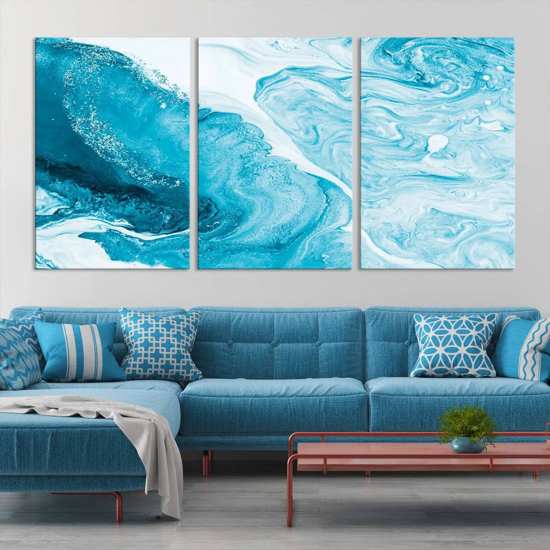 A modern living room showcasing the Bright Blue Marble Fluid Effect Wall Art Abstract Canvas, complete with a gallery-wrapped finish.