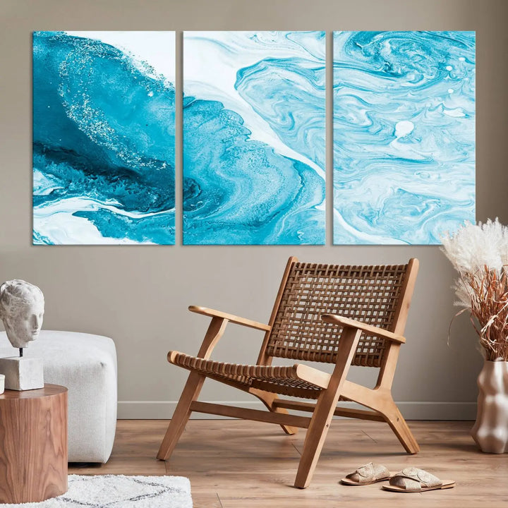 A modern living room showcasing the Bright Blue Marble Fluid Effect Wall Art Abstract Canvas, complete with a gallery-wrapped finish.