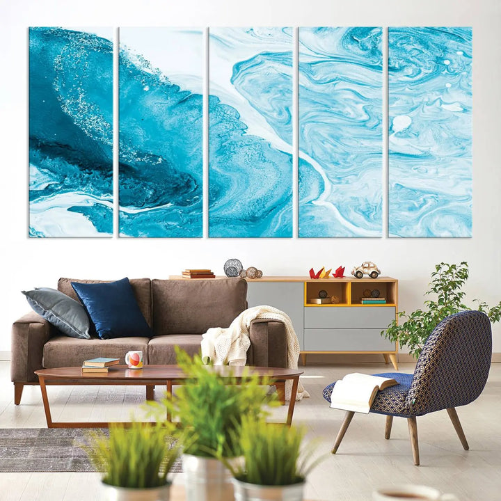 A modern living room showcasing the Bright Blue Marble Fluid Effect Wall Art Abstract Canvas, complete with a gallery-wrapped finish.