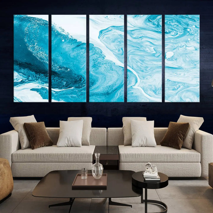 A modern living room showcasing the Bright Blue Marble Fluid Effect Wall Art Abstract Canvas, complete with a gallery-wrapped finish.