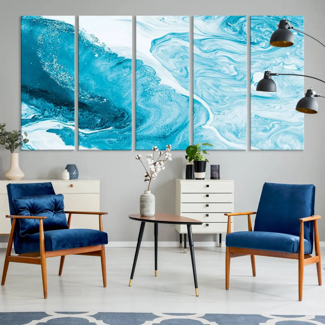 A modern living room showcasing the Bright Blue Marble Fluid Effect Wall Art Abstract Canvas, complete with a gallery-wrapped finish.