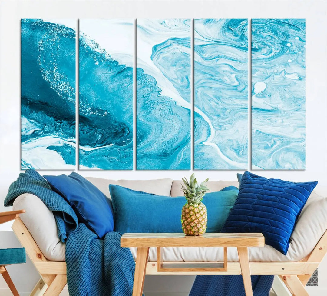 A modern living room showcasing the Bright Blue Marble Fluid Effect Wall Art Abstract Canvas, complete with a gallery-wrapped finish.