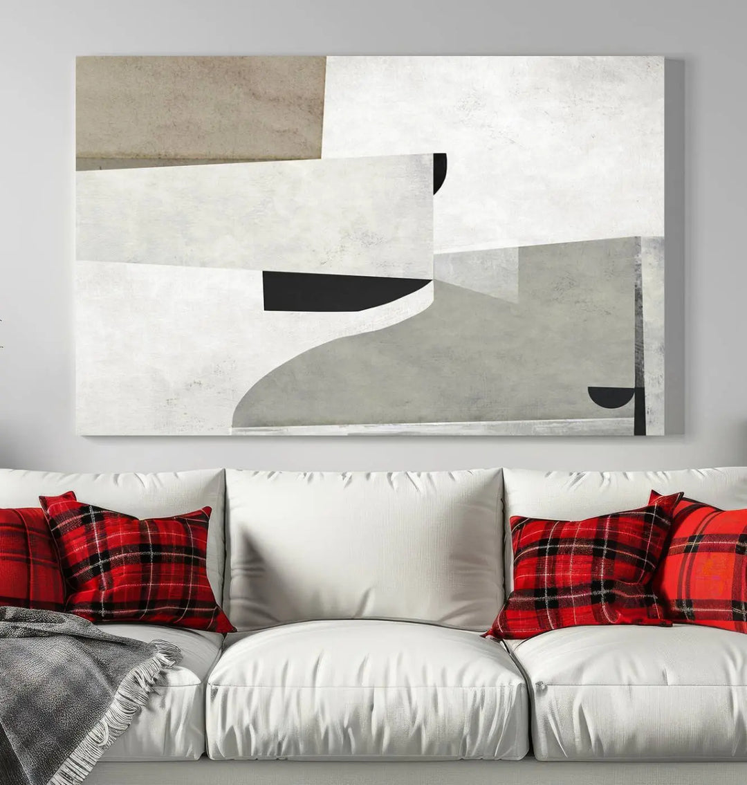 The Brown Gray Figures Abstract Wall Art Canvas Print is displayed as a triptych on a dark wall. The piece is gallery wrapped, offering a seamless finish and enhanced durability due to its UV-protective coating.