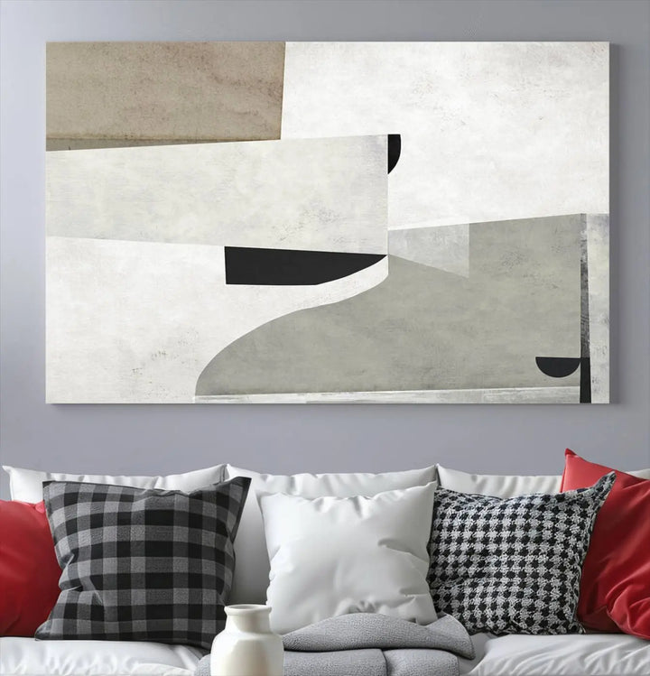 The Brown Gray Figures Abstract Wall Art Canvas Print is displayed as a triptych on a dark wall. The piece is gallery wrapped, offering a seamless finish and enhanced durability due to its UV-protective coating.