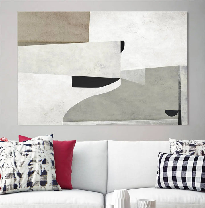 The Brown Gray Figures Abstract Wall Art Canvas Print is displayed as a triptych on a dark wall. The piece is gallery wrapped, offering a seamless finish and enhanced durability due to its UV-protective coating.