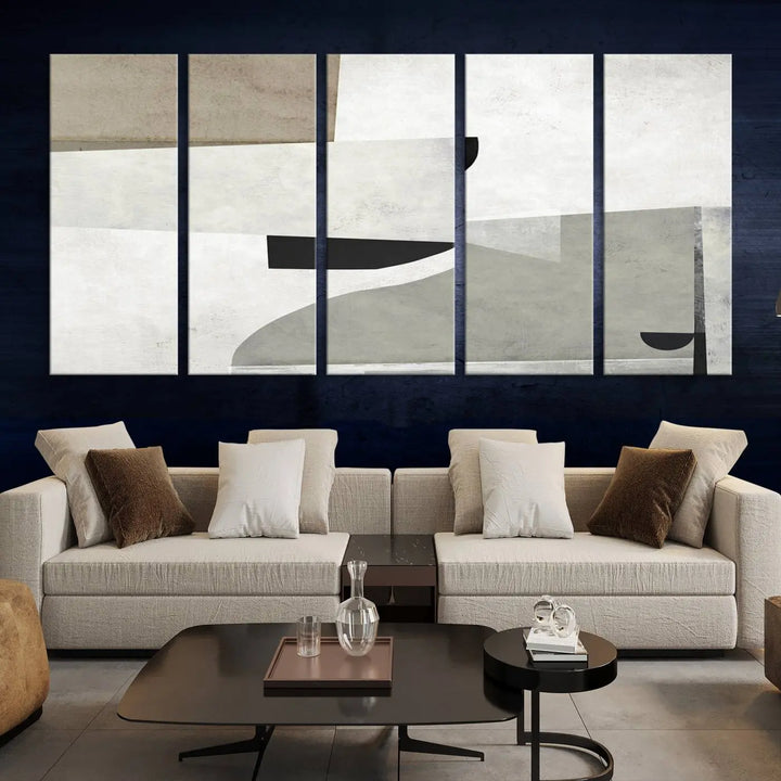 The Brown Gray Figures Abstract Wall Art Canvas Print is displayed as a triptych on a dark wall. The piece is gallery wrapped, offering a seamless finish and enhanced durability due to its UV-protective coating.