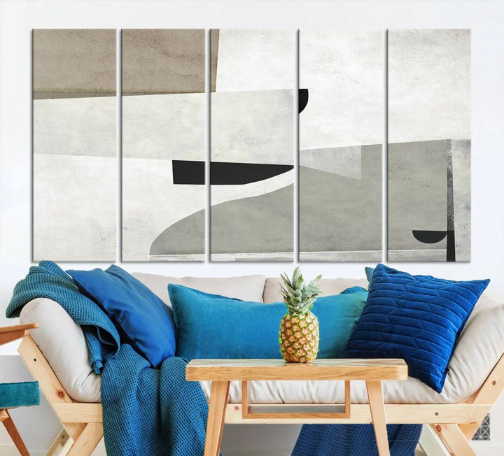 The Brown Gray Figures Abstract Wall Art Canvas Print is displayed as a triptych on a dark wall. The piece is gallery wrapped, offering a seamless finish and enhanced durability due to its UV-protective coating.