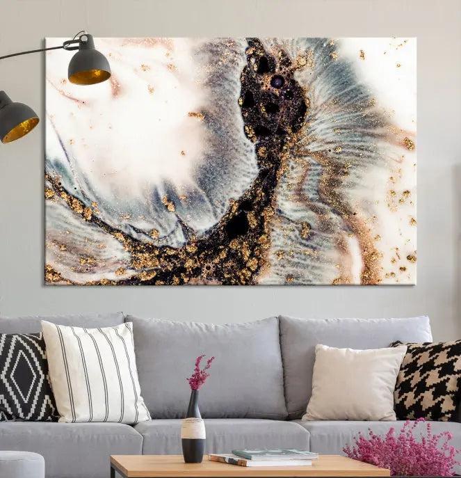 The Brown Marble Fluid Effect Wall Art Abstract Canvas Wall Art Print, with its mesmerizing black, white, and gold swirls, brings an exquisite touch to the space. This museum-quality canvas is elegantly displayed in a modern living room setting.