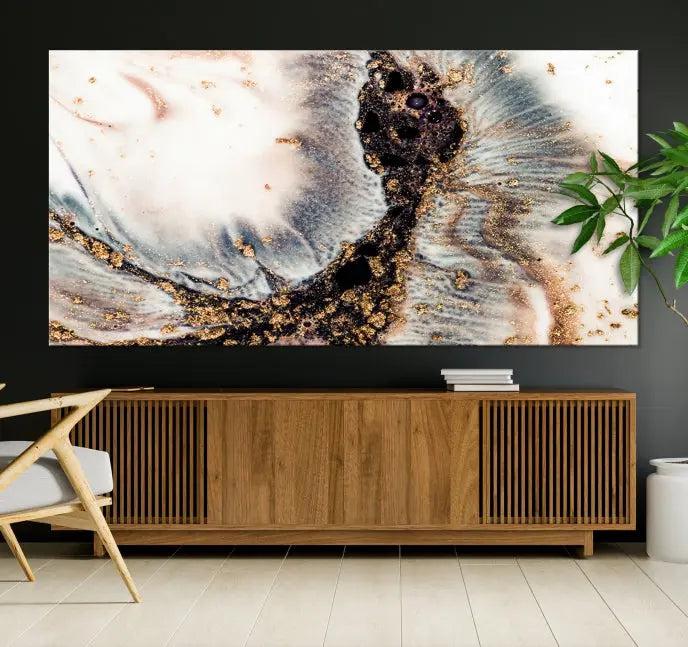 The Brown Marble Fluid Effect Wall Art Abstract Canvas Wall Art Print, with its mesmerizing black, white, and gold swirls, brings an exquisite touch to the space. This museum-quality canvas is elegantly displayed in a modern living room setting.