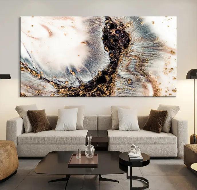 The Brown Marble Fluid Effect Wall Art Abstract Canvas Wall Art Print, with its mesmerizing black, white, and gold swirls, brings an exquisite touch to the space. This museum-quality canvas is elegantly displayed in a modern living room setting.