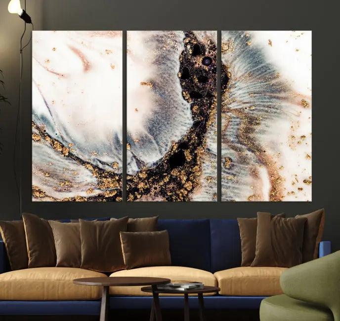 The Brown Marble Fluid Effect Wall Art Abstract Canvas Wall Art Print, with its mesmerizing black, white, and gold swirls, brings an exquisite touch to the space. This museum-quality canvas is elegantly displayed in a modern living room setting.