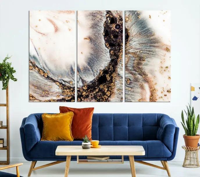 The Brown Marble Fluid Effect Wall Art Abstract Canvas Wall Art Print, with its mesmerizing black, white, and gold swirls, brings an exquisite touch to the space. This museum-quality canvas is elegantly displayed in a modern living room setting.