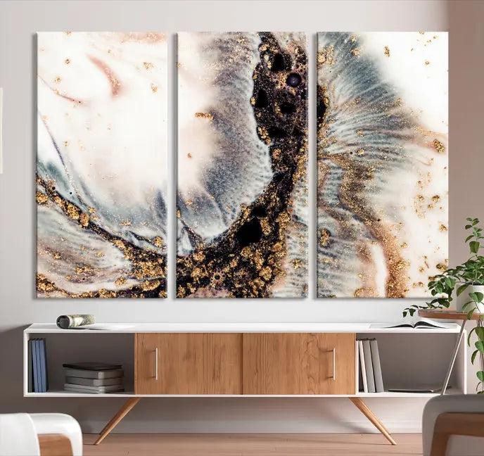 The Brown Marble Fluid Effect Wall Art Abstract Canvas Wall Art Print, with its mesmerizing black, white, and gold swirls, brings an exquisite touch to the space. This museum-quality canvas is elegantly displayed in a modern living room setting.