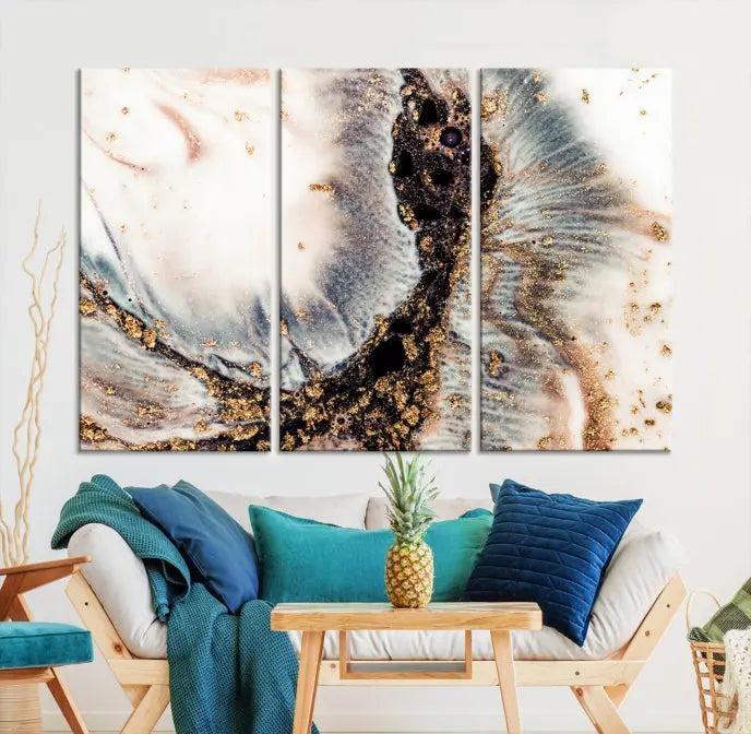 The Brown Marble Fluid Effect Wall Art Abstract Canvas Wall Art Print, with its mesmerizing black, white, and gold swirls, brings an exquisite touch to the space. This museum-quality canvas is elegantly displayed in a modern living room setting.