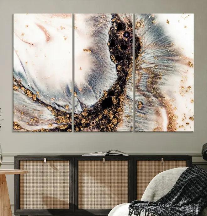 The Brown Marble Fluid Effect Wall Art Abstract Canvas Wall Art Print, with its mesmerizing black, white, and gold swirls, brings an exquisite touch to the space. This museum-quality canvas is elegantly displayed in a modern living room setting.